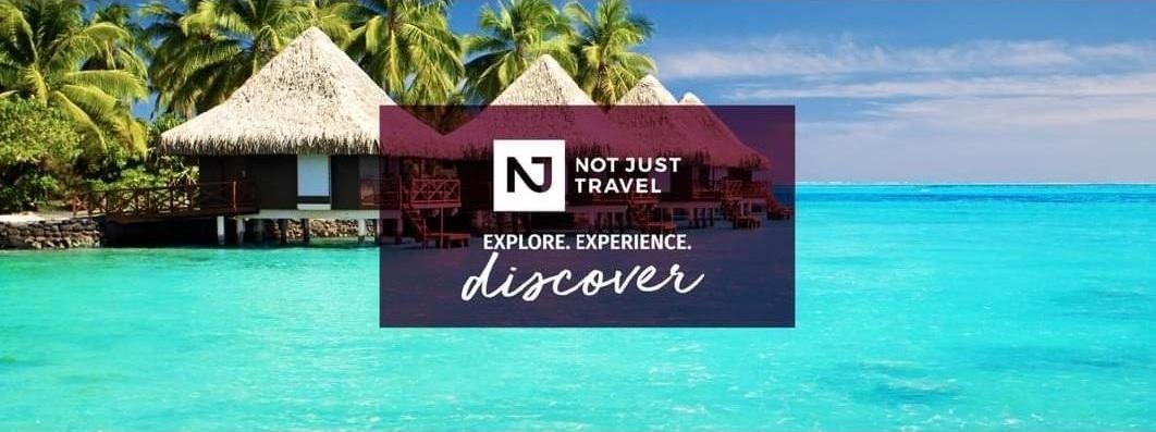 Palm trees and thatched roofs huts over the sea. Not Just Travel logo with tagline Explore, Experience, Discover.