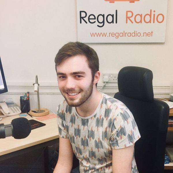 Ross sitting in the studio and smiling.